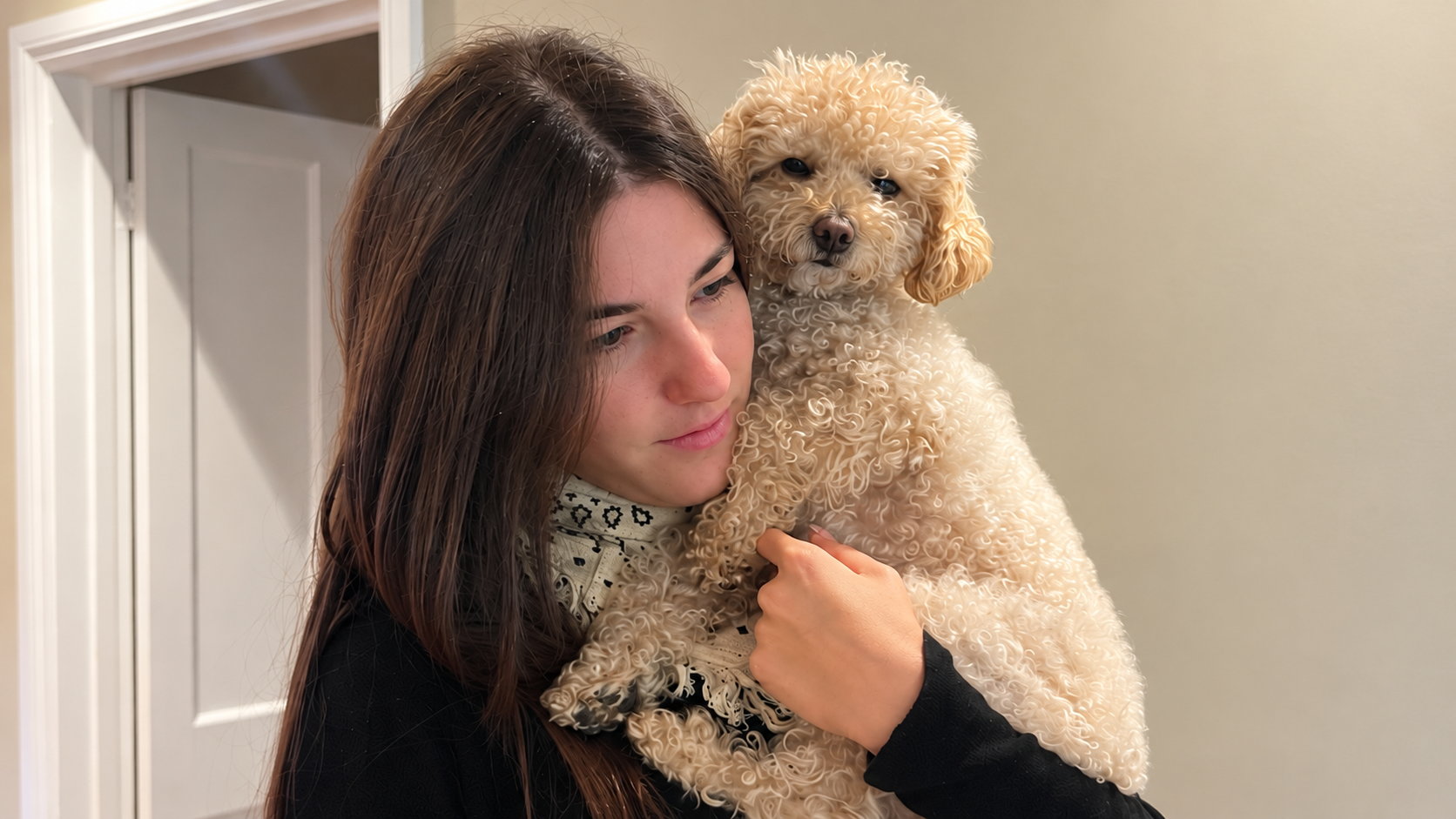 Girl cuddling a small dog